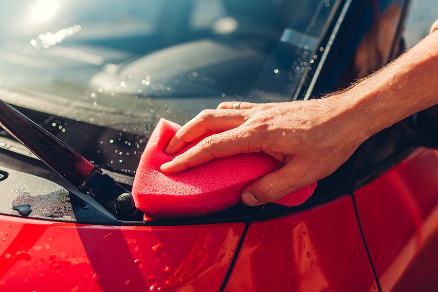 Car Washing. Man Cleaning Car With Soapy Sponge Outdoors. Close-